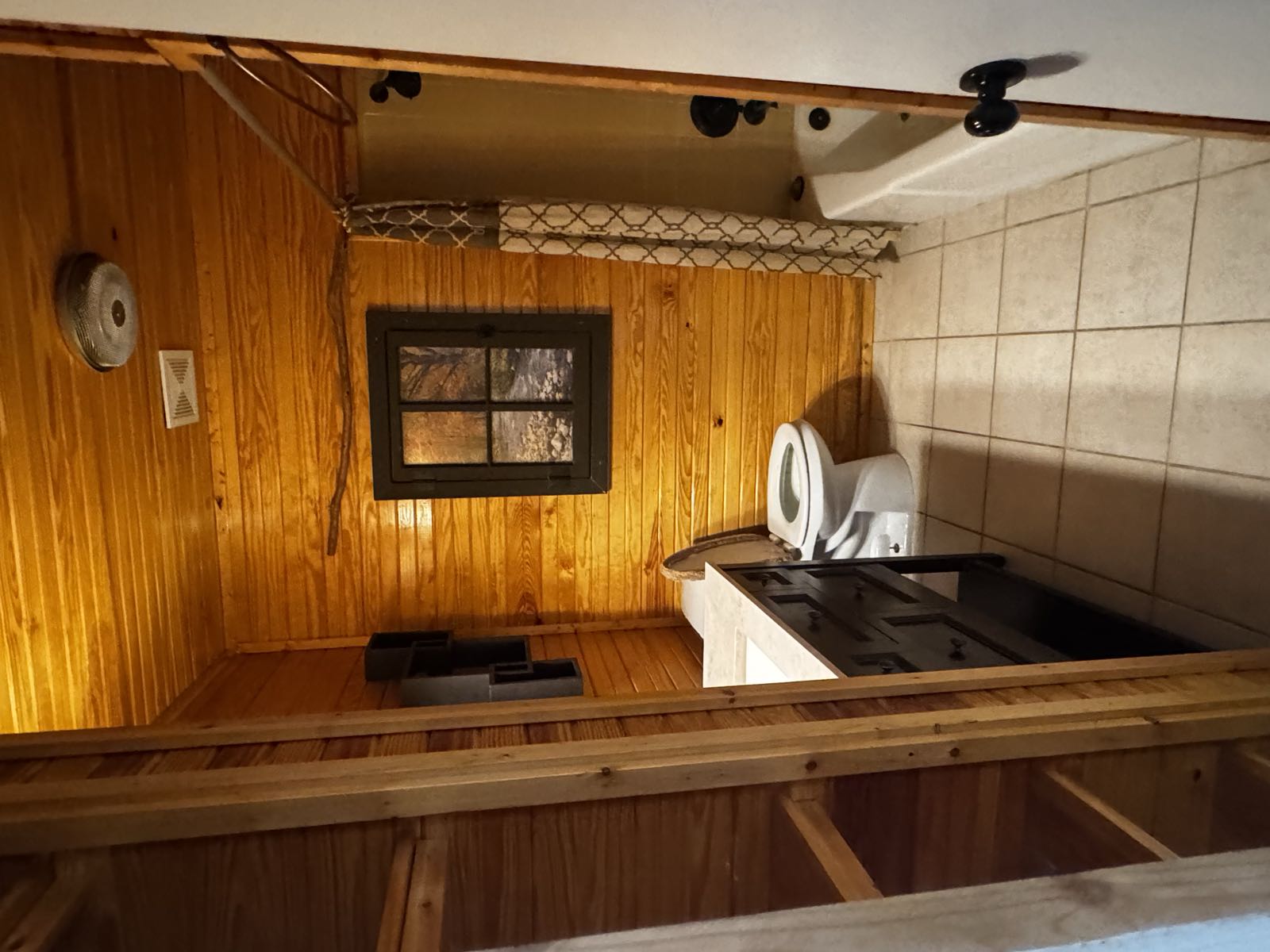Dated wood-paneled bathroom before remodel