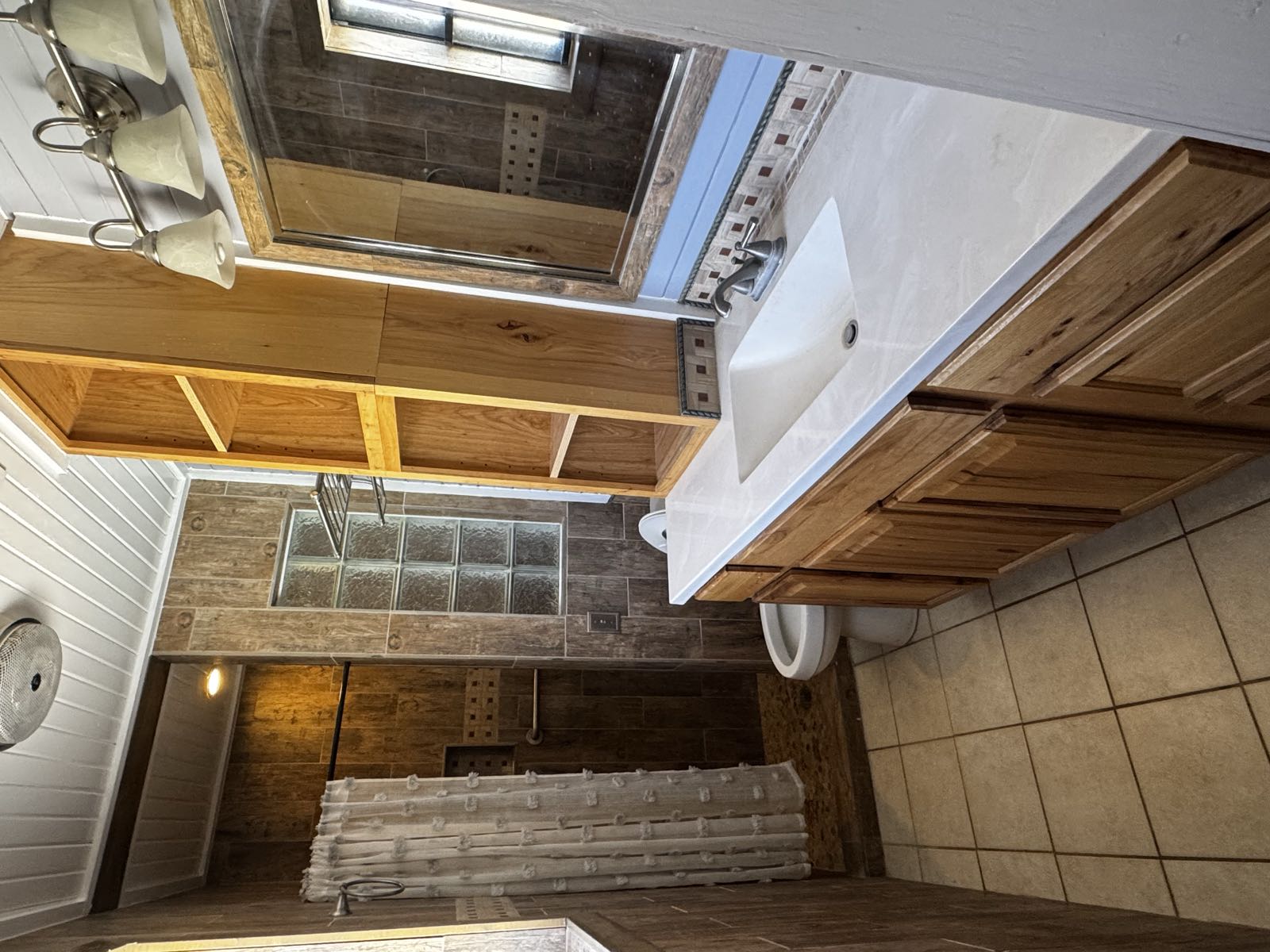 Dated bathroom with enclosed shower before remodel